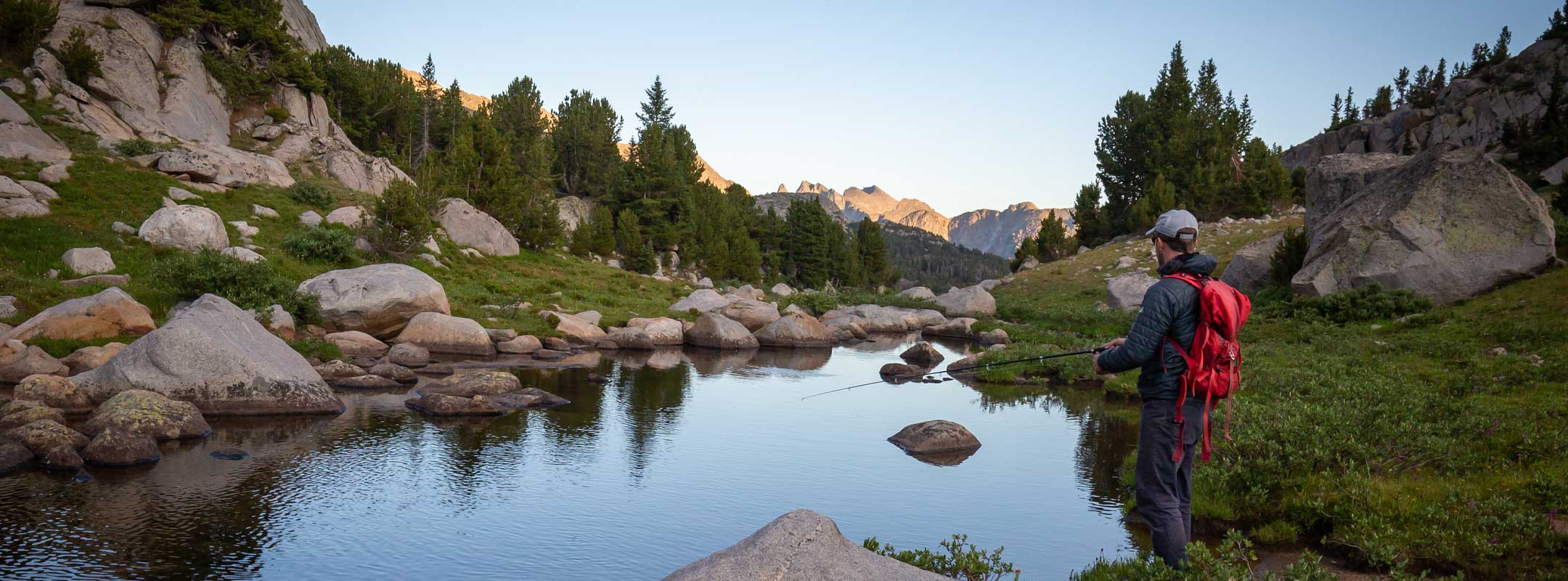 Fly fishing in the mountain lake with adams dry flies